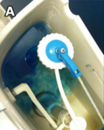 Blue water leak detector in an open toilet tank